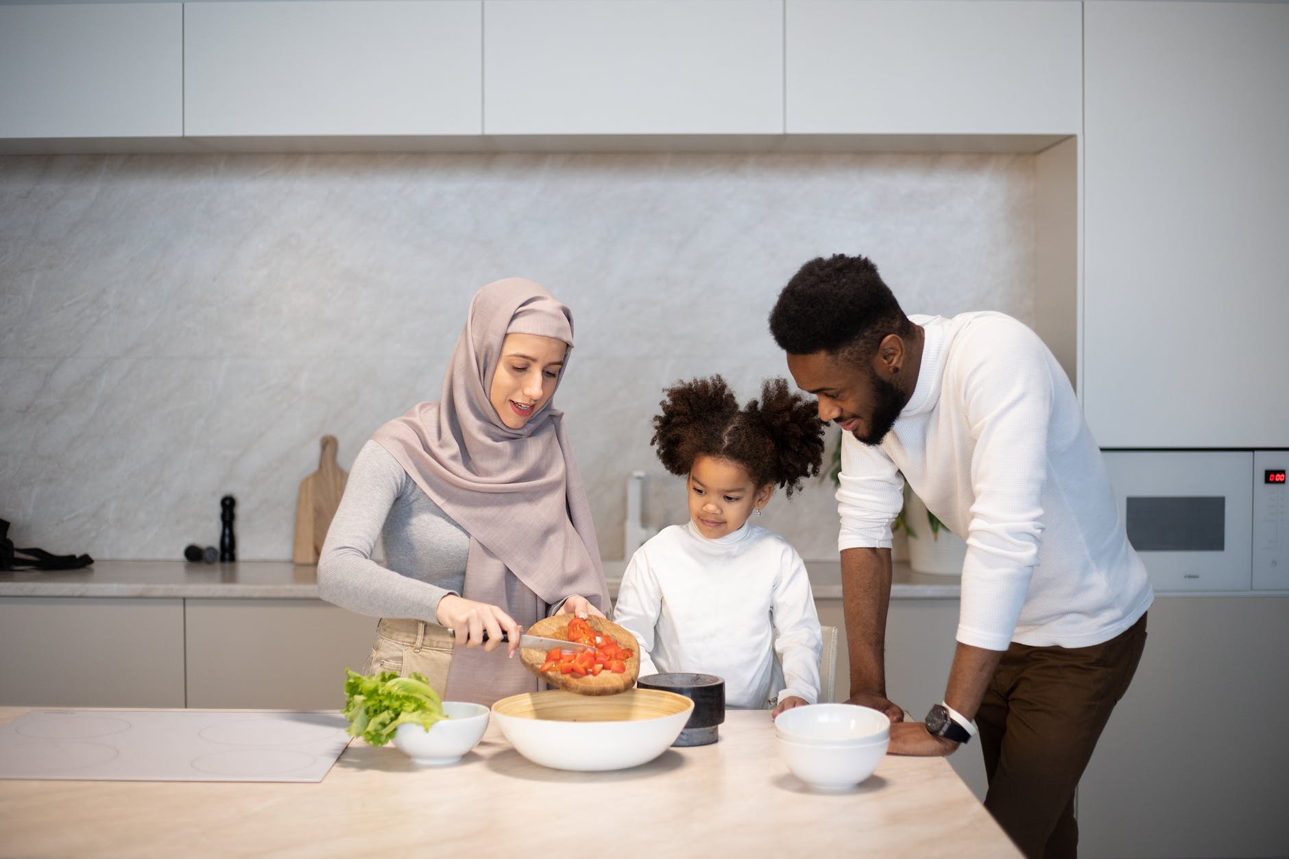 multiethnic family cooking in kitchen at home