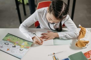 Girl writing on notebook