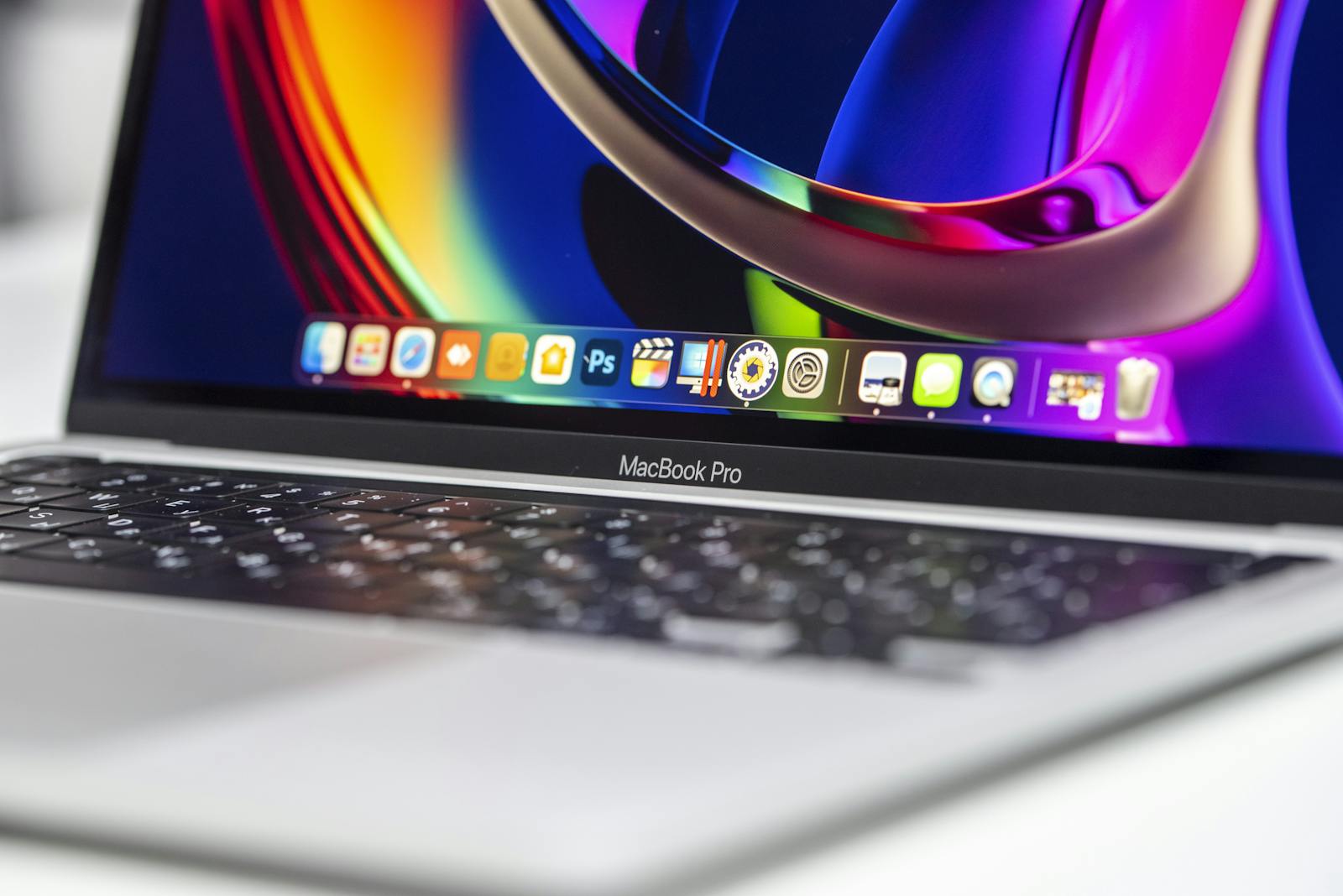 A vibrant close-up of a MacBook Pro showcasing its colorful screen and keyboard.