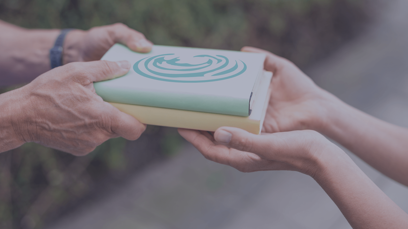 2 books being exchanged by 2 people. Give a book, Give Literacy