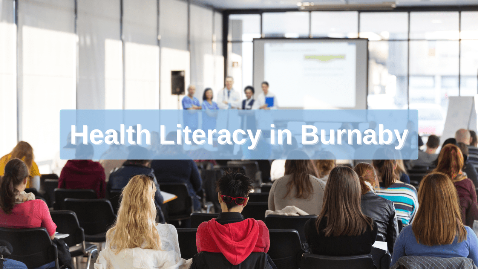 Healthcare professionals leading a conference on community health, with a text overlay that reads ‘Health Literacy in Burnaby.